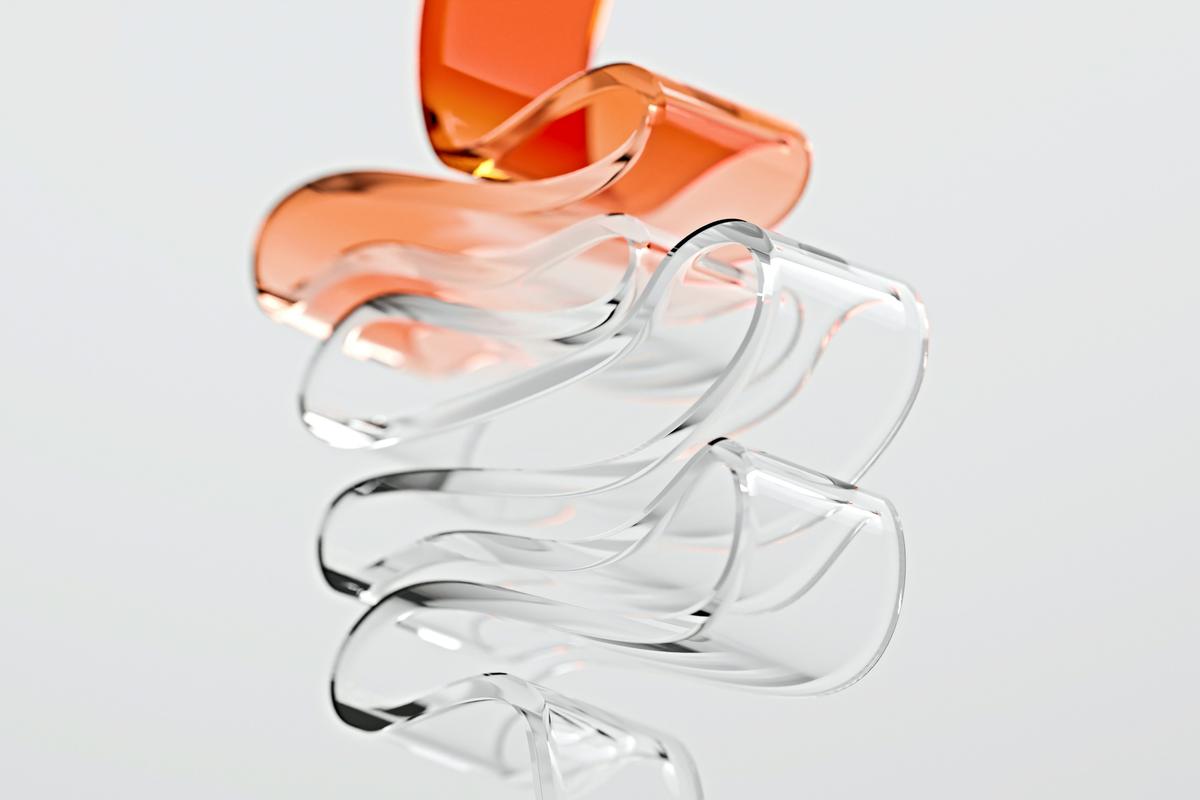 Escultura abstracta de vidrio con un elemento naranja
